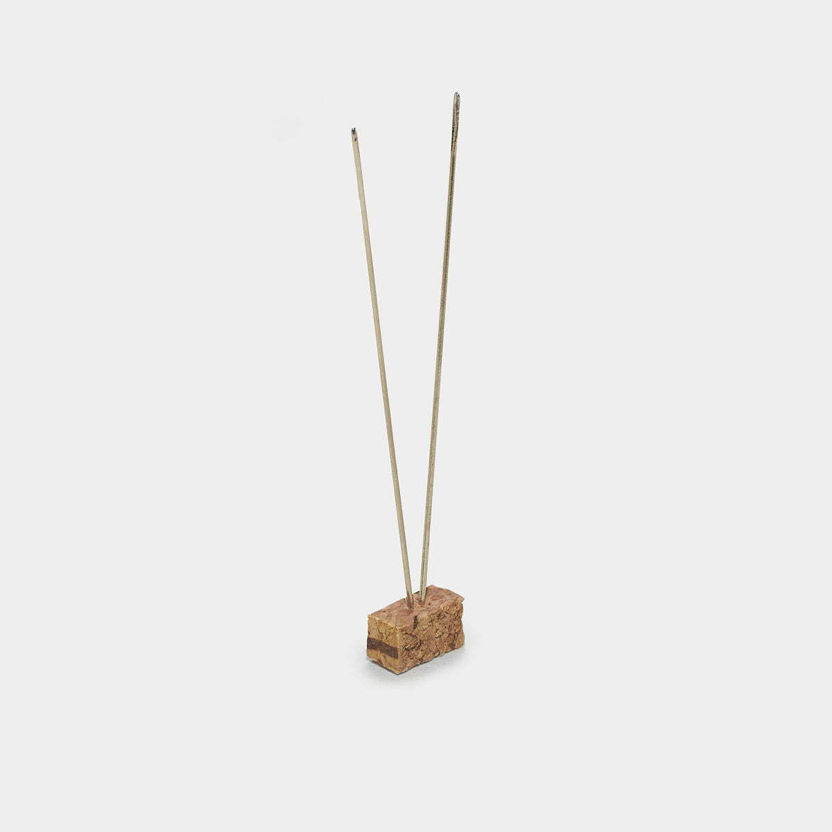Beadsology bead embroidery kit includes a beading needle inserted into a small cork block for display.